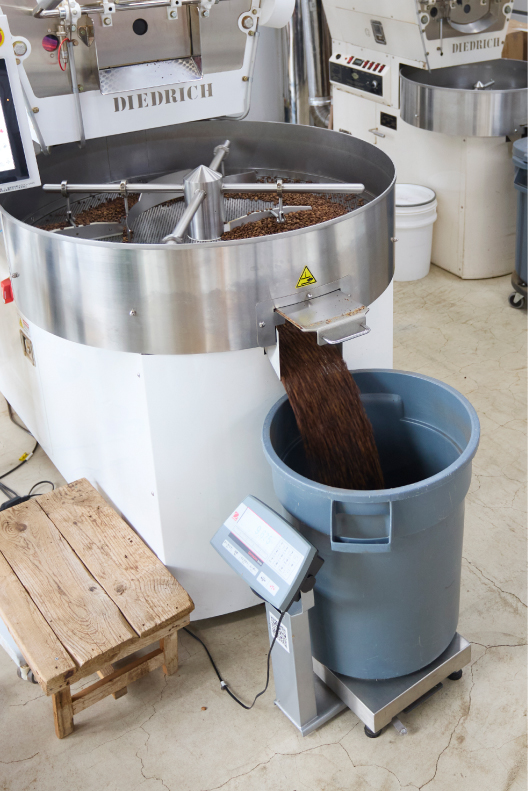 焙煎を終えたコーヒー豆を受け止めるグレーのブルートコンテナ